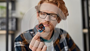 Chip in hand of blurred partial male IT technician