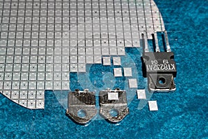 The chip of a high-power transistor according to the Darlington scheme on a divided silicon wafer.