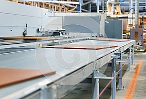 Chipboards on conveyer at furniture factory