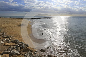 Chipiona Beach and breakwater on a cloudy day photo