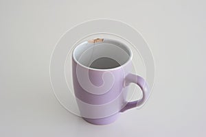 Chipped coffee mug on white background, shallow depth of field