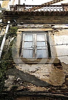 Chipped facade with old green wooden window