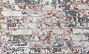 Chipped red white blue paint brick wall