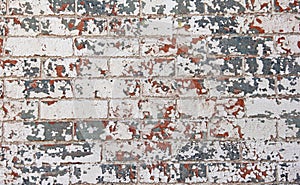 Chipped red white blue paint brick wall photo