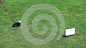 Chipping a golf ball onto the green with golf club