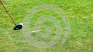 chipping a golf ball onto the green with golf club