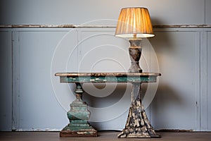 a chippy painted side table with an antique lamp