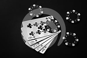 Chips and black playing cards with a winning combination of high card. The concept of luck or fortune in a poker club