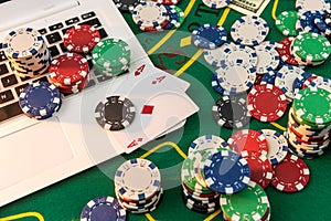 Chips, cards money and laptop for poker online or casino gambling. Risk for win money