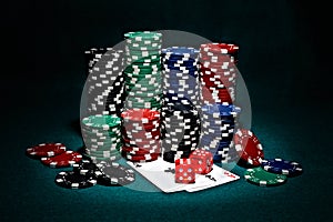 Chips for poker with pair of aces and dice