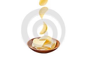 Chips in wooden plate and falling ones isolated on white background