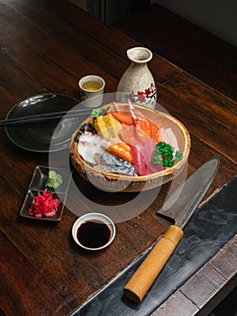 Chirashi Sushi on the wooden table with a Japannese sushi knife