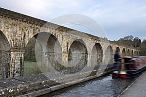 Chirk aqueduct and viaduct on the Llangollen canal, on the border of England and Wales. With a barge crossing
