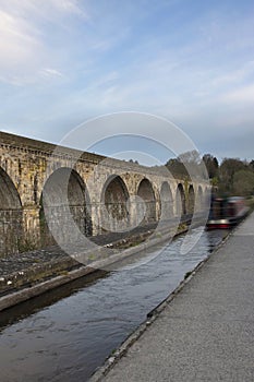 Chirk aqueduct and viaduct on the Llangollen canal, on the border of England and Wales. With a barge crossing