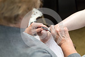 Chiropodist gives a medical treatment at home photo