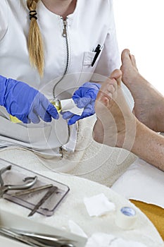 Chiropodist gives a medical treatment at home