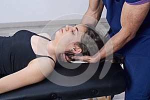 Chiropractic getting mobilization cervical spine of a woman. Manual therapy. Neurological physical examination. Osteopathy,