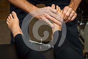Chiropractor Adjusts the Foot of a Young Girl his Integrator is