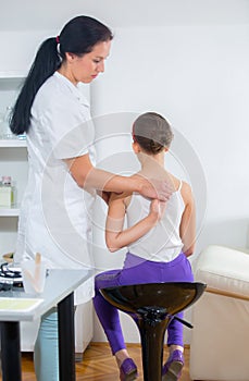 Chiropractor doing adjustment on female patient