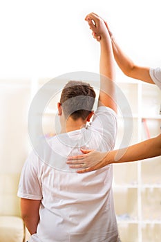 Chiropractor doing adjustment on male patient. Selective focus