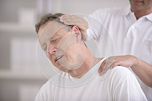 Chiropractor doing neck adjustment photo