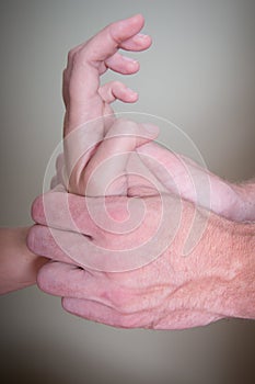 Chiropractor doing Reflexology Female Patient hand