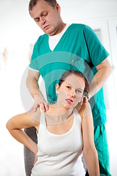 Chiropractor massage the female patient spine and back