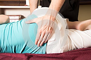 Chiropractor massage patient lower back ,spin