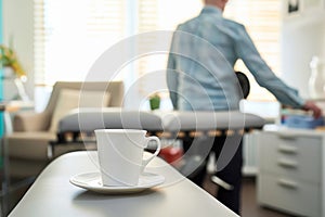 chiropractor in office, coffee cup on adjustment table