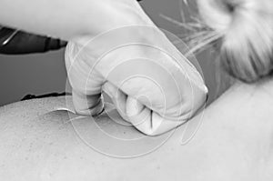 Chiropractor, physiotherapist giving a back massage to a woman p