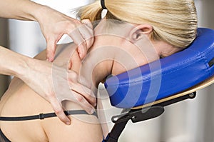 Chiropractor, physiotherapist giving a back massage to a woman p