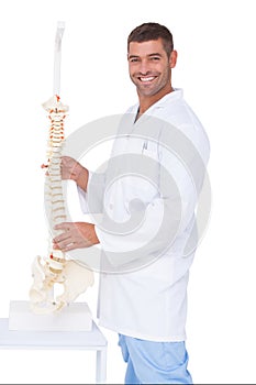 Chiropractor showing spine model to camera