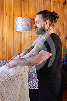 Chiropractor stretching spine of woman