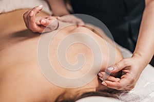 Chiropractor working on the shoulder joint of a patient