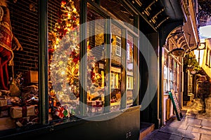 A Chirstmas night view of Shambles, a historic street in York featuring preserved medieval timber-framed buildings with jettied photo