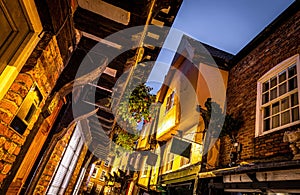 A Chirstmas night view of Shambles, a historic street in York featuring preserved medieval timber-framed buildings with jettied photo