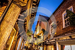 A Chirstmas night view of Shambles, a historic street in York featuring preserved medieval timber-framed buildings with jettied photo