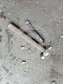 Chisel and hammer on concrete slab. Very old construction tools. Renovation of old premises. Preparing for repair work