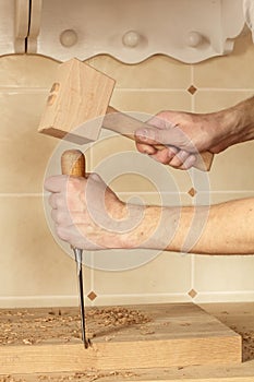 Chisel and mallet in hands