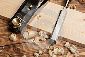 Chisel and small block plane with wood shavings