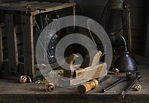 Chisel and small block plane with wood shavings. Carpenter cabinet maker hand tools on the workbench.