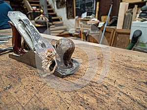 Chisel and small block plane with wood shavings. Carpenter cabinet maker hand tools on the workbench.