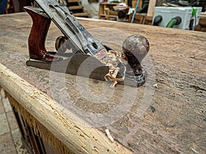 Chisel and small block plane with wood shavings. Carpenter cabinet maker hand tools on the workbench.