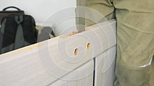 Chiseling a groove in a wooden door for inserting a lock and handles.