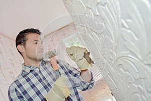 Chiselling away at old wall motif