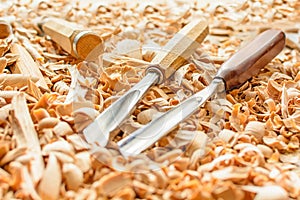 Chisels laid in wooden shavings on the desk