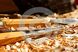 Chisels laid in wooden shavings on the desk