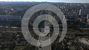 CHISINAU, MOLDOVA - Aerial drone view flight over the Buildings, Grigore Vieru street. Cars on a bridge passing a river