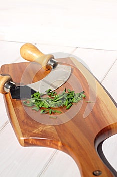 Chives chopped on wooden chopping board D