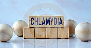 CHLAMYDIA - word on wooden cubes on a light background with balls